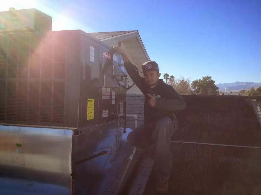HVAC technician performing Boiler Repair on a rooftop unit in Myrtletown